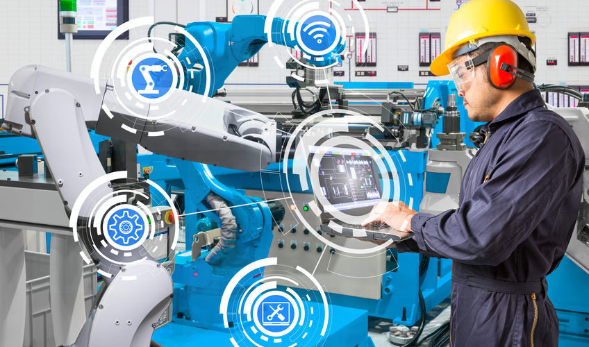 Engineer using laptop computer for maintenance automatic robotic Engineer using laptop computer for maintenance automatic robotic hand machine tool at industrial manufacture factory